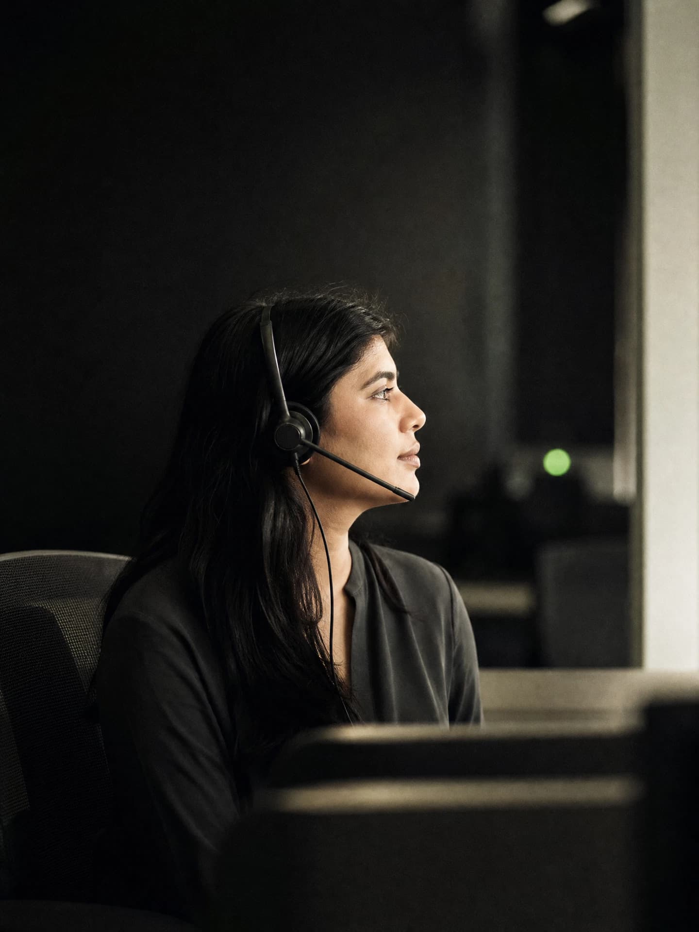 Operator wearing a headset in a calm operations room